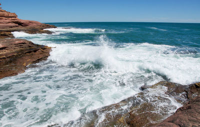 Scenic view of sea against clear blue sky