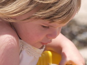 Girl playing on sand at beach