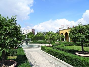 Lawn in garden against sky