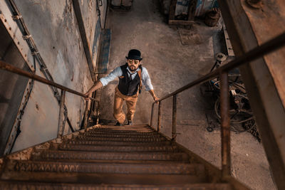 Full length of man standing on staircase