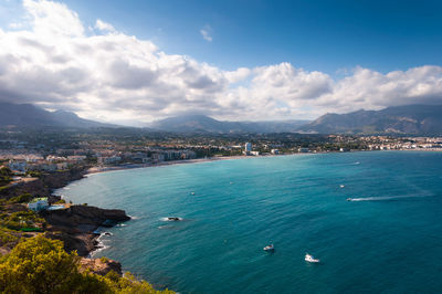 High angle view of sea and cityscape against sky