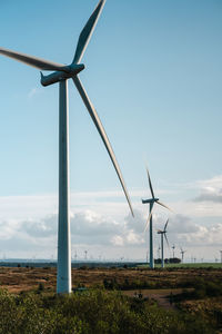 Low angle view of windmill against sky