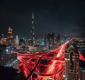 Aerial view of illuminated buildings in city at night