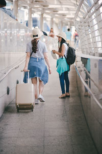 Tourists on footpath in city