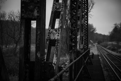 Railroad tracks by trees against sky