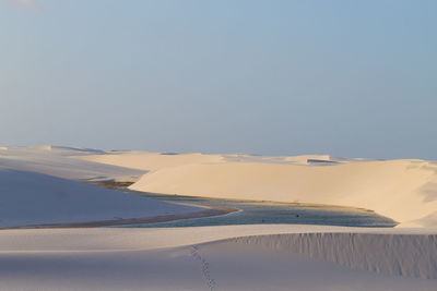 Scenic view of desert against clear sky during winter