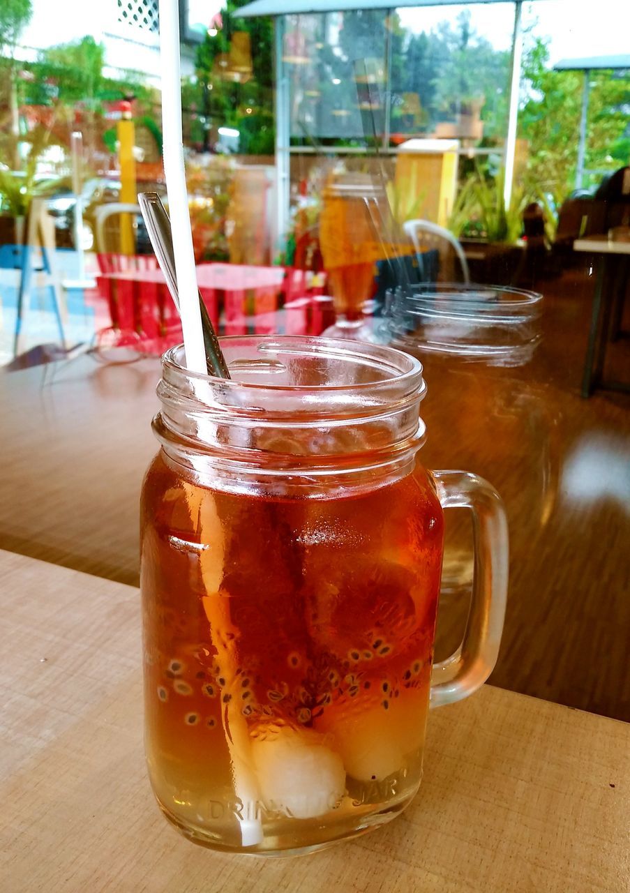 CLOSE-UP OF BEER GLASS ON TABLE