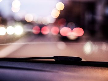 Defocused lights seen through car windshield at night