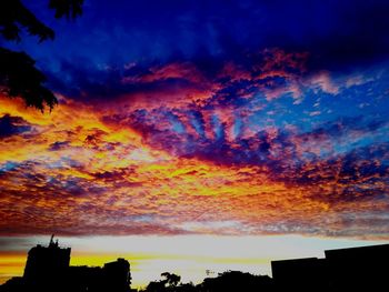 Low angle view of silhouette buildings against sky during sunset