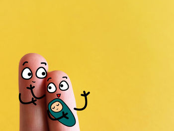 Close-up of stuffed toy against yellow background