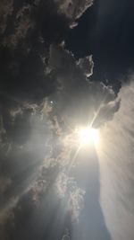 Low angle view of sun shining in sky