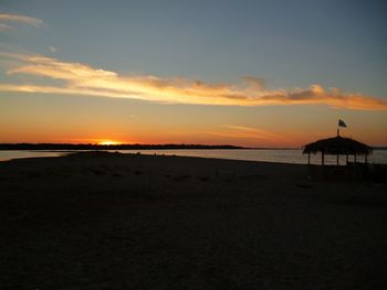 Scenic view of beach against sky during sunset