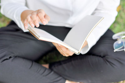 Midsection of man holding mobile phone