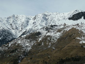 Low angle view of snow covered mountain against sky