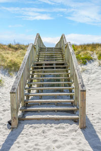 Steps on landscape against sky