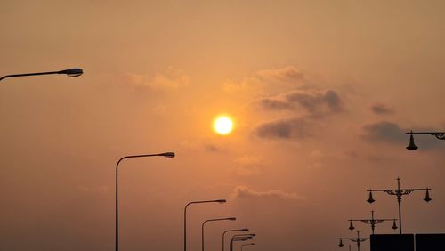 Low angle view of street light against sky during sunset