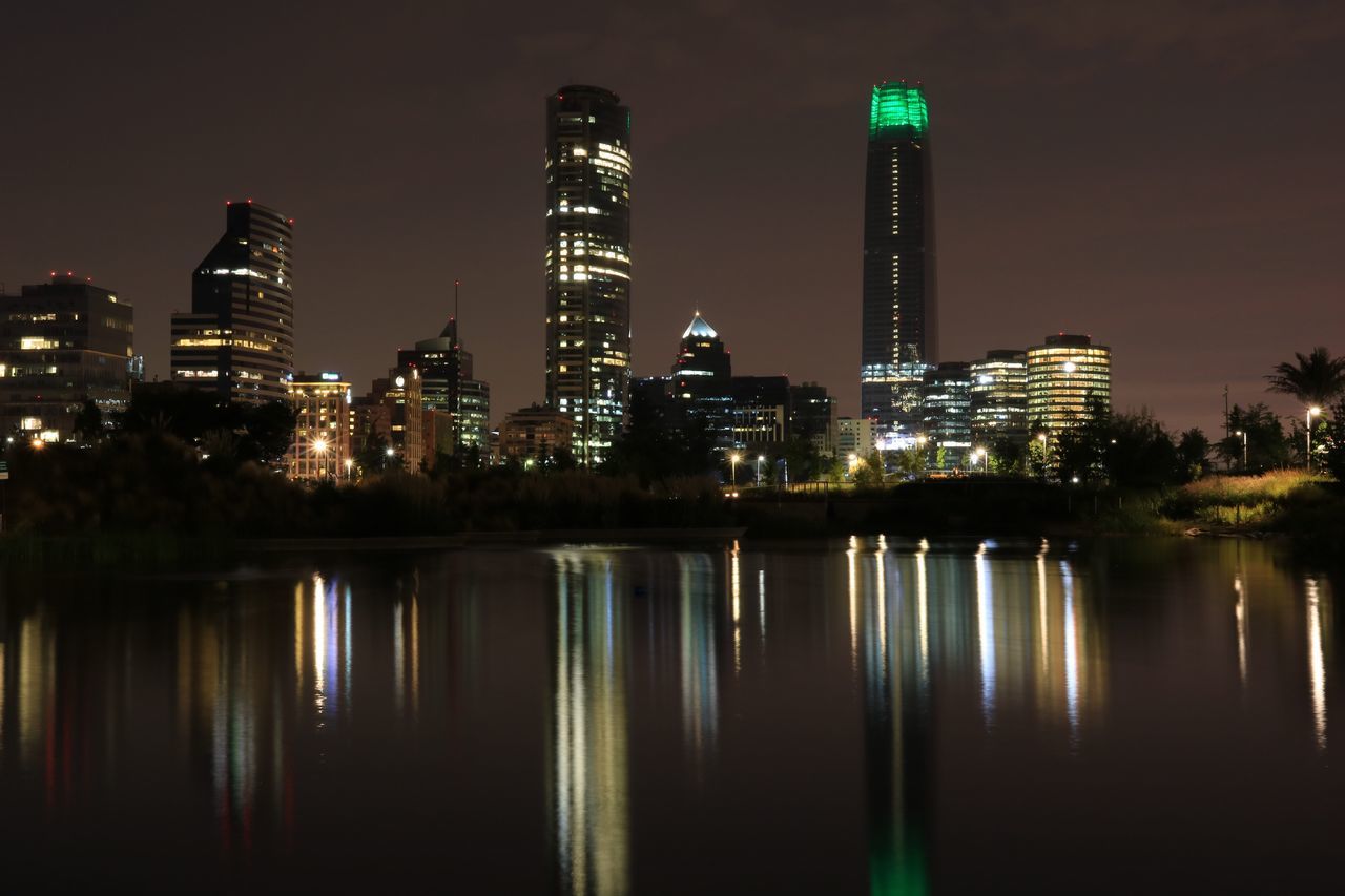 ILLUMINATED CITY AT WATERFRONT