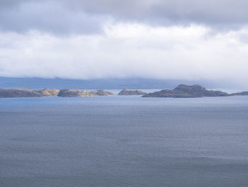 Scenic view of sea and mountains against sky