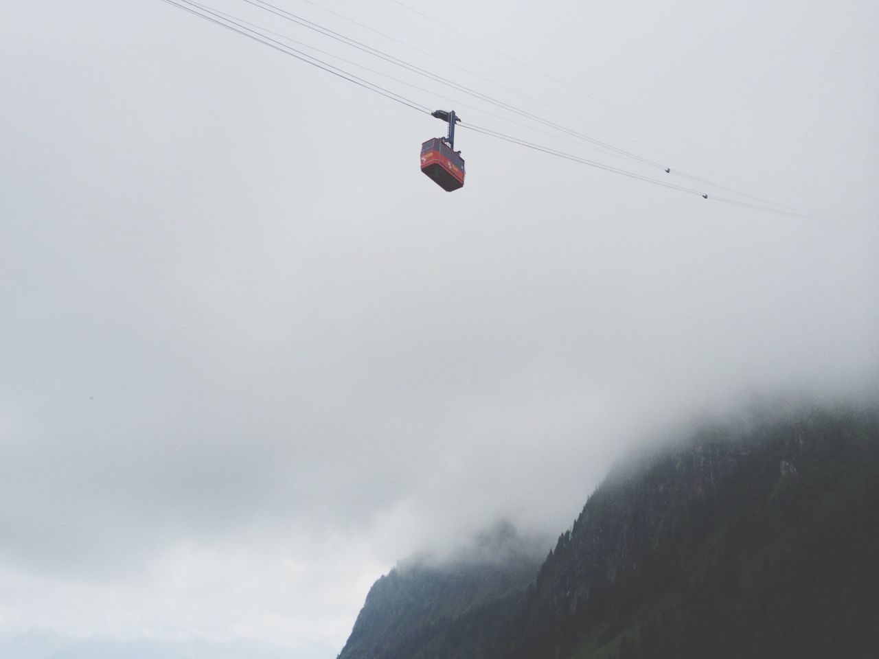 flying, mid-air, transportation, low angle view, air vehicle, mode of transport, sky, airplane, clear sky, day, flag, adventure, mountain, travel, extreme sports, outdoors, nature, copy space, paragliding, on the move