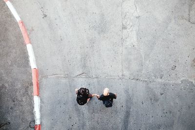 Directly above shot of couple standing on road