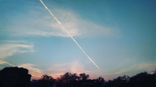 Low angle view of vapor trails in sky