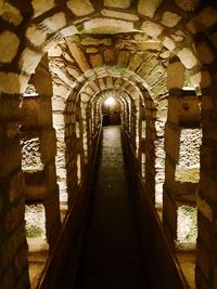 Empty corridor in illuminated building