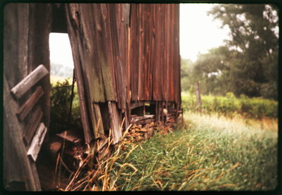 Old wooden structure on grassy field