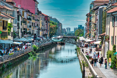 Bridge over canal amidst buildings in city