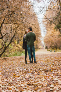 Full length of man and woman standing in park