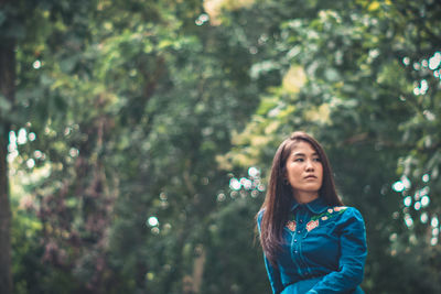 Portrait of a beautiful young woman in forest