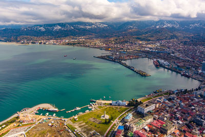 High angle view of buildings by sea against sky