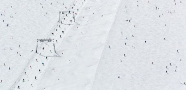 Aerial view of people on snowy landscape