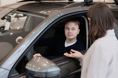 Portrait of young woman in car