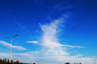 Low angle view of street light against blue sky