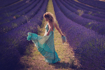 Rear view of woman standing on field