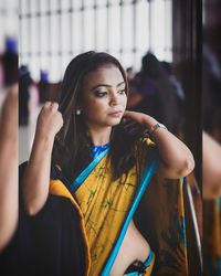 Portrait of beautiful young woman looking away