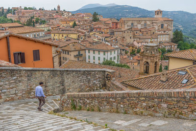 People at town square by buildings in city