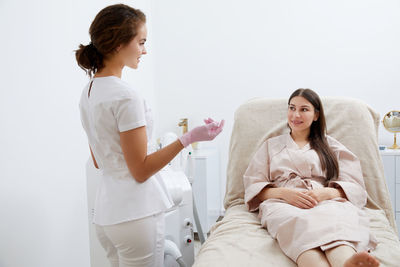 Portrait of female doctor examining patient at clinic