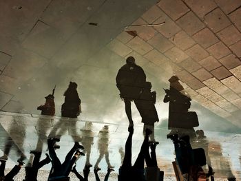 Upside down view of the people reflections on the street.