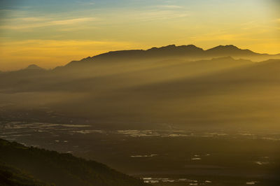 Scenic view of silhouette mountains against sky during sunset