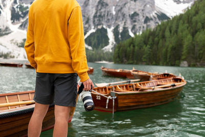 Man standing on boat in lake