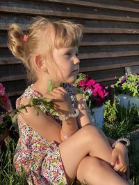 Midsection of woman with pink flowers