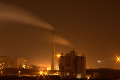 Illuminated city against sky at night