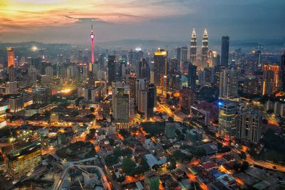 Aerial view of city lit up at night