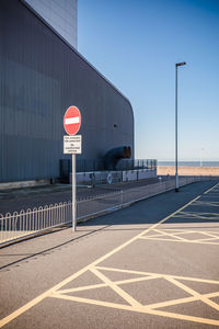 Road sign against clear sky