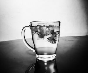 Close-up of drink in glass on table against wall