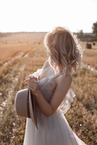 Side view of young woman using mobile phone