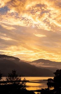 Scenic view of lake against romantic sky at sunset