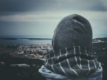 Close-up of man with cityscape in background