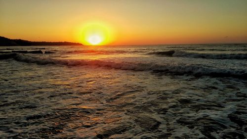 View of calm beach at sunset